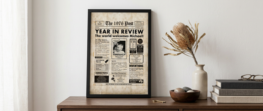 Framed 50th birthday newspaper print styled on a timber console table with dried banksia stem in an Australian home interior