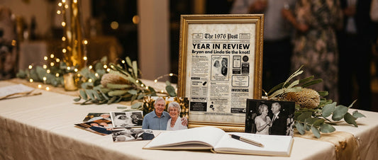 Gold-framed A3 personalised 50th wedding anniversary print displayed on a party table with photos and a guest book