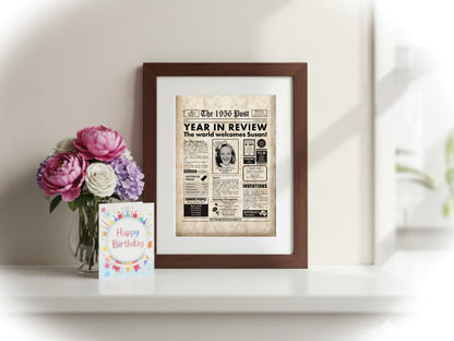 70th birthday digital newspaper poster print, featuring aged paper textures, framed, beside flowers and a birthday card.