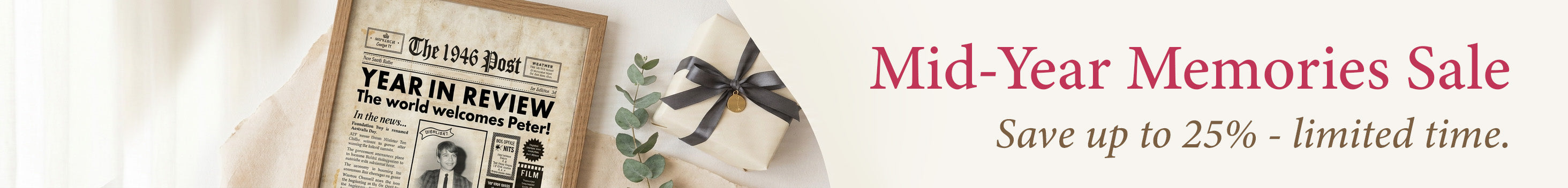 Personalised year-you-were-born newspaper print in a timber frame beside a wrapped gift with eucalyptus — Mid-Year Memories Sale, save up to 25%